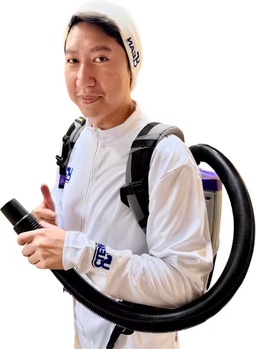 UpClean commercial cleaning team member with a backpack vacuum giving a thumbs up, serving Kelowna and the Okanagan